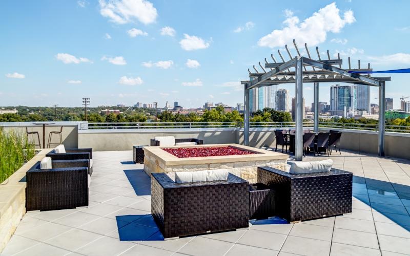 a patio with a table and chairs and a view of a city