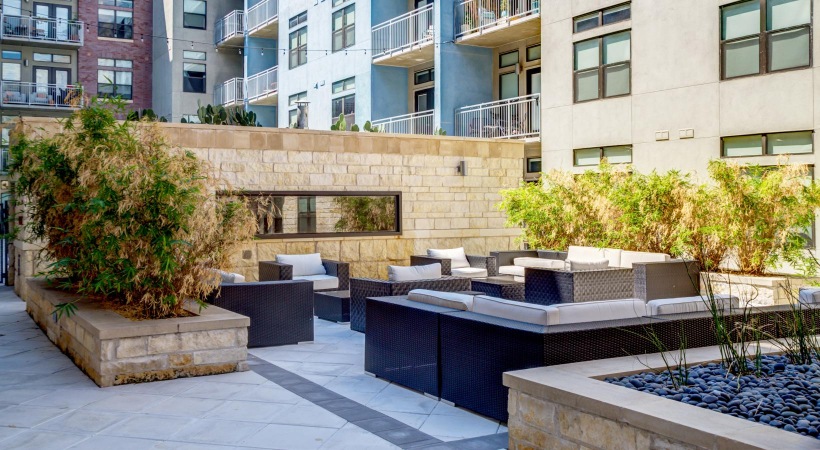 a courtyard with a fountain and trees