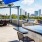 a patio with tables and chairs and a view of a city