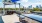 a patio with tables and chairs and a view of a city